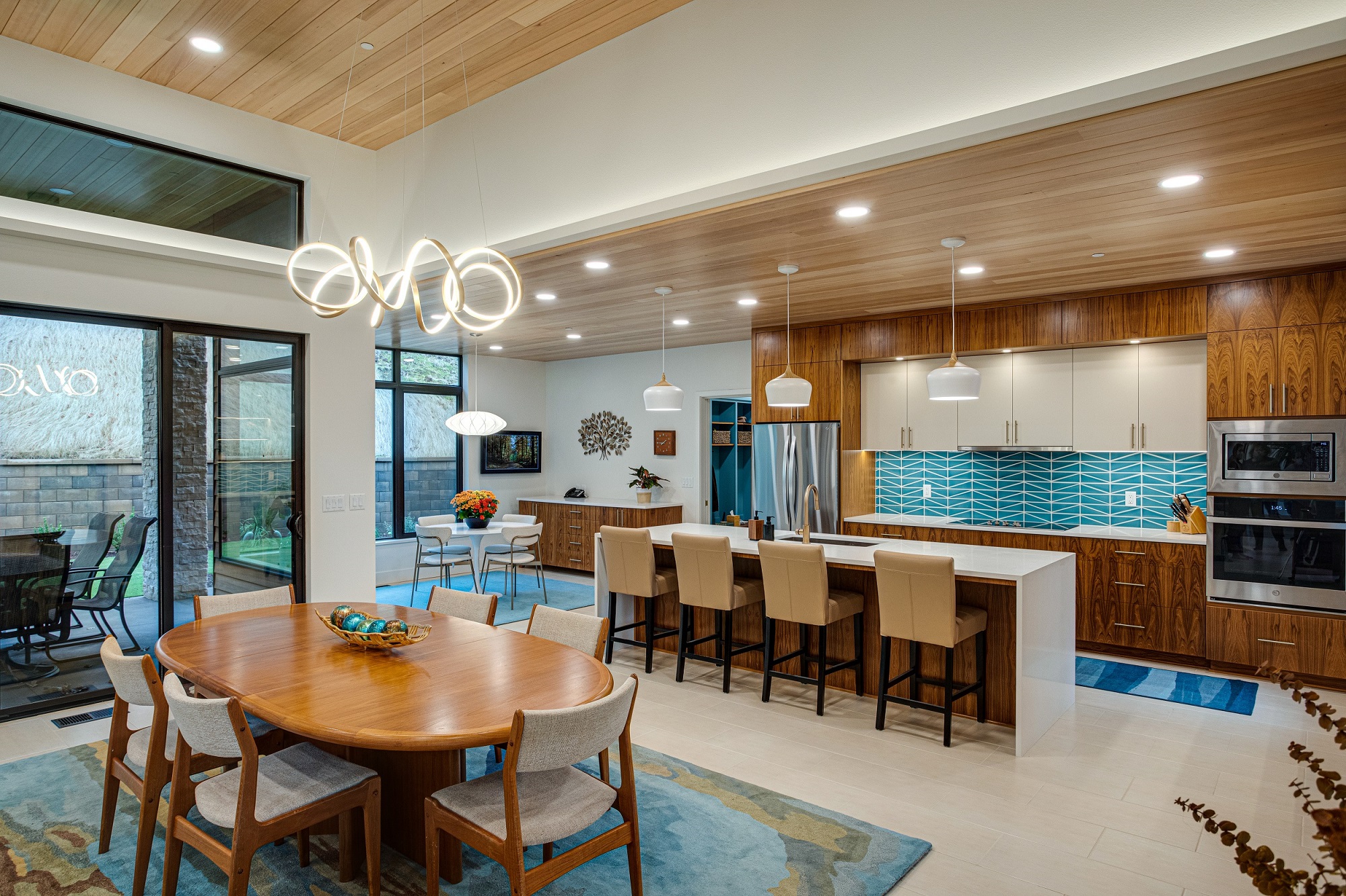 Open concept mid century modern dining room to kitchen with outdoor sight-lines