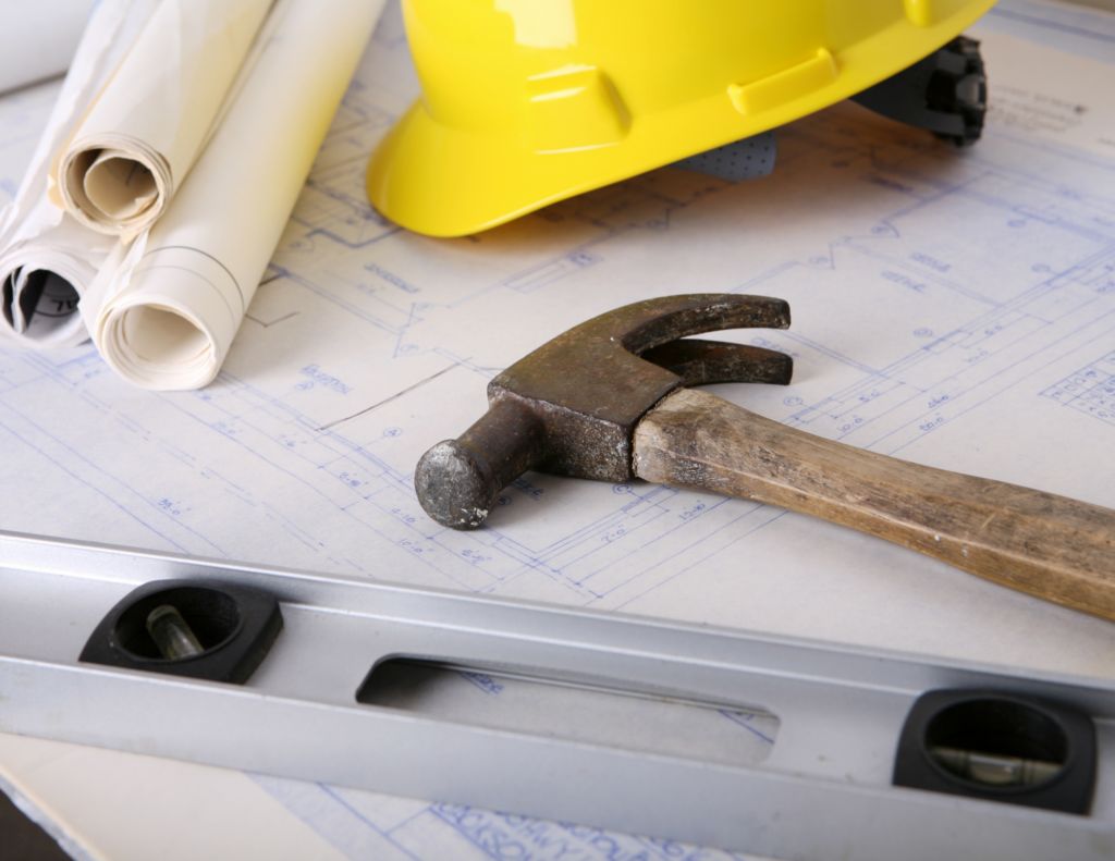 what to expect during construction shows tools, hard hat and blueprints