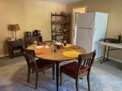 what to expect during construction involves a temporary make shift kitchen located in a spare bedroom with dining room table, fridge, shelves with spices and food and a table with propane cooktop