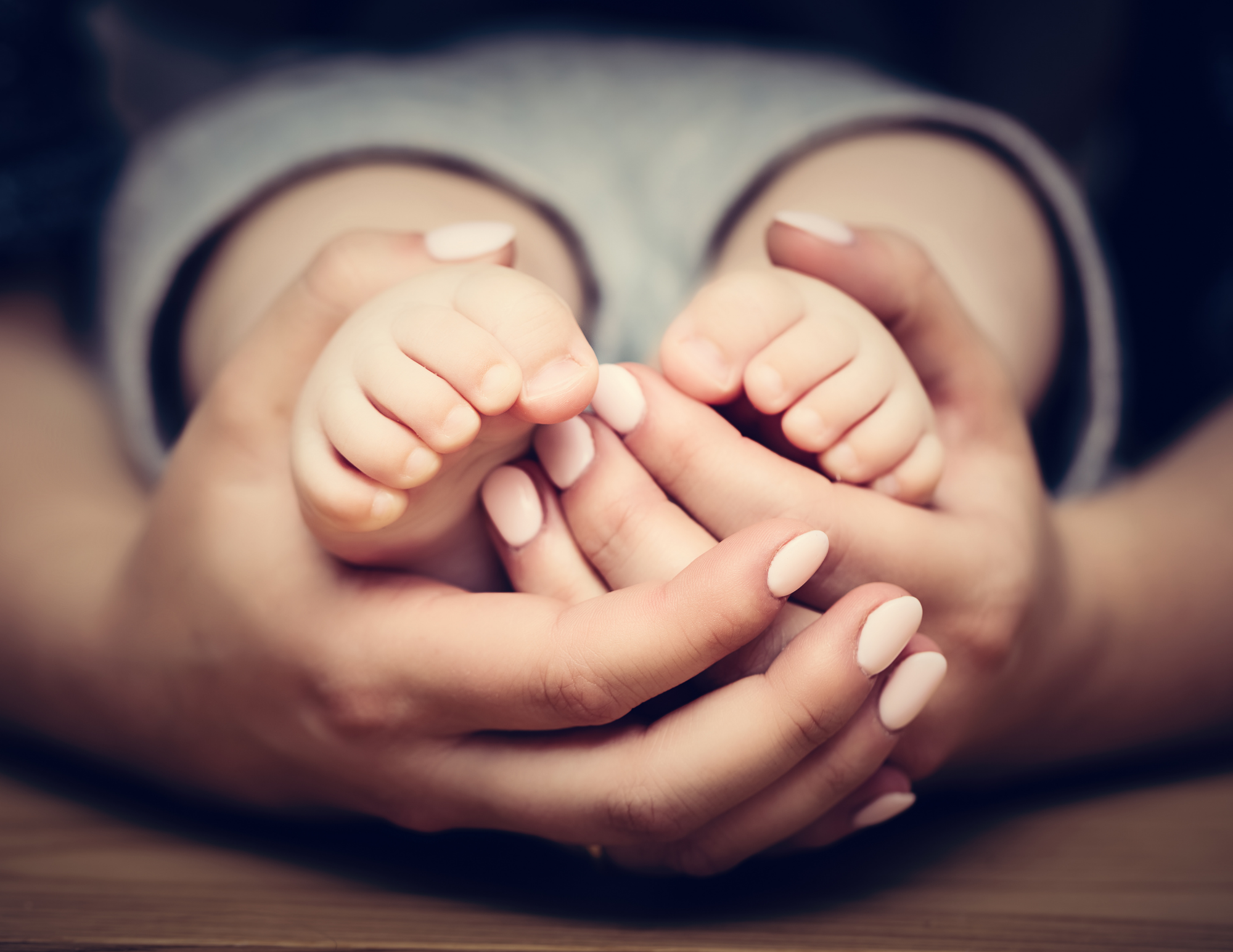 safe families benefit cardv woman holding baby's feet