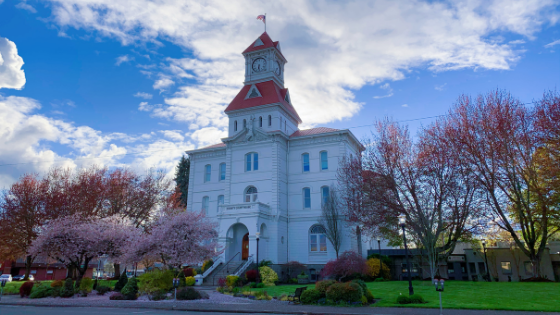 Benton County Courthouse White Building with red roof clocktower and American flag atop located in Willamette Valley