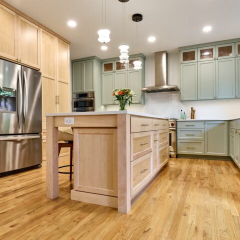 kitchen design remodel with pale sage and soft maple custom cabinetry, white quartz countertops and white tile backsplash