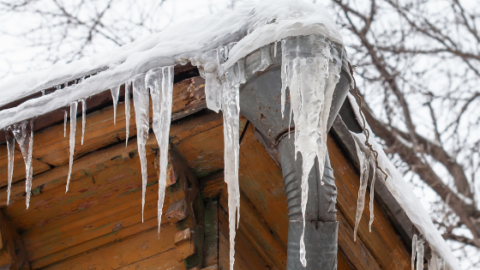 prep your home for winter ice falling off gutters of home