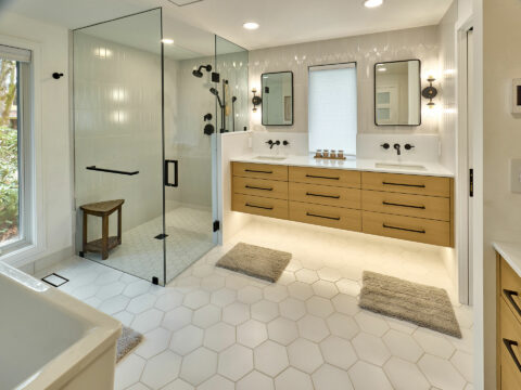 Modern master suite with hex tile floors to wood floor transition and custom cabinetry
